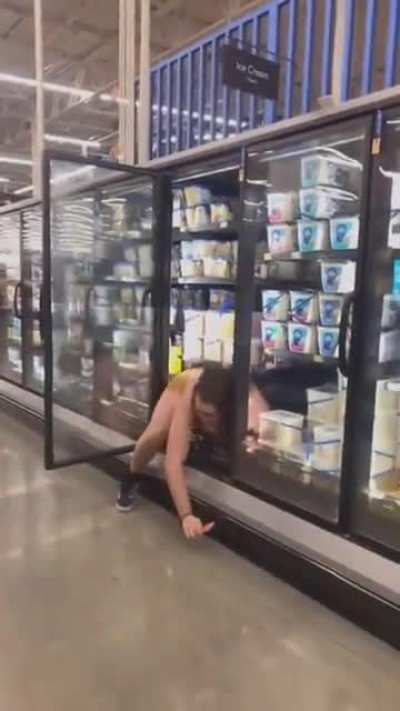 Half naked man gets in refrigerator at walmart and makes mess.