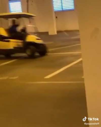 Racing a golf cart in an empty parking lot