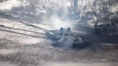 A Russian who is on fire is running away from his tank which is also on fire and about to explode