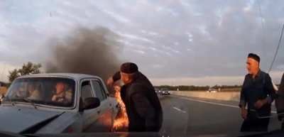 Bystanders help elderly people in a car accident.