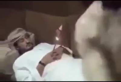Man puts rocket between his friend's hands while he sleeps
