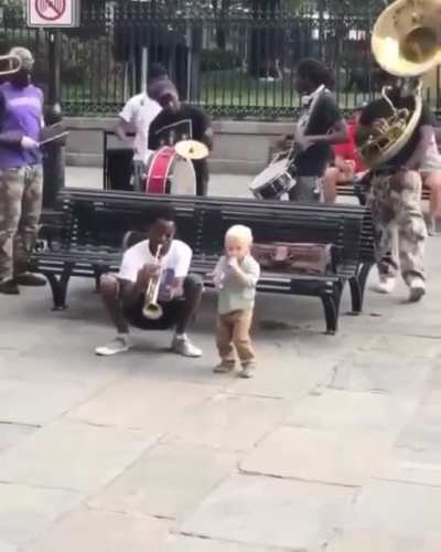 This kid is jamming his heart out with street musicians