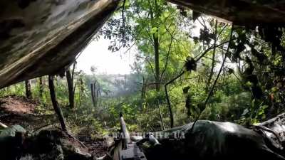 Soldier operating a machine gun against Russian troops movement, somewhere in the eastern direction. June 2024. Bravo Company of the 1st infantry battalion of the International Legion