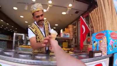 Turkish ice cream man playing with a customer