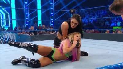 Sonya applies a tight chinlock as she controls a flailing and squirming Alexa
