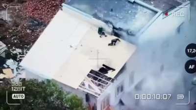 Russian drone precise attacks civilian workers who repairing roof damaged after shelling in Kreson