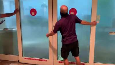 Severe thunderstorm pushes door open at Pensacola, Florida