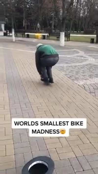 pedaling the smallest bike in the world