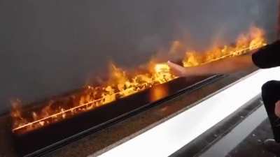 These flames are touchable. They are not even flames, actually as they are made by water vapor lit by LED lights