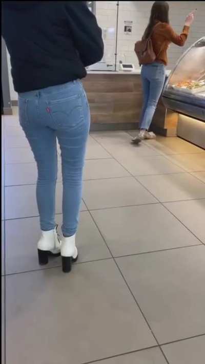 Girl pees her jeans in a deli.