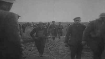 German POWs carries wounded American soldiers to the dressing station in Missy-Aux-Bois, France (July 16, 1918)