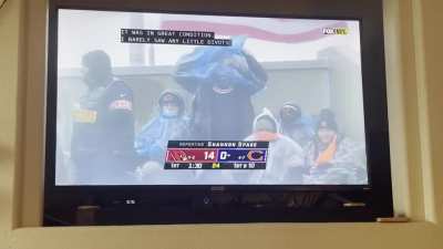 Bears fan struggling to put poncho on in wet & blustery conditions!