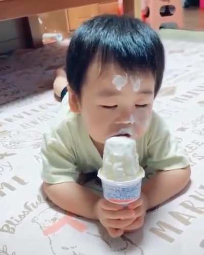 Fighting to stay awake to eat his ice cream