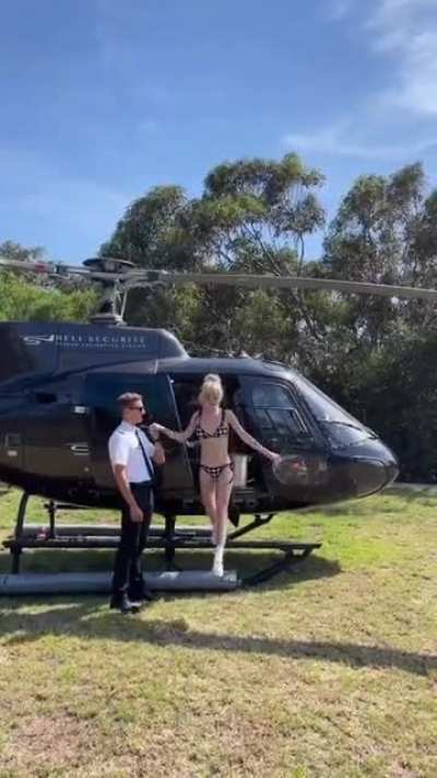 Kiernan Shipka, coming out of a helicopter in a bikinee