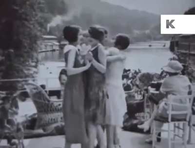 A group of friends dancing and having a party near a river circa 1926