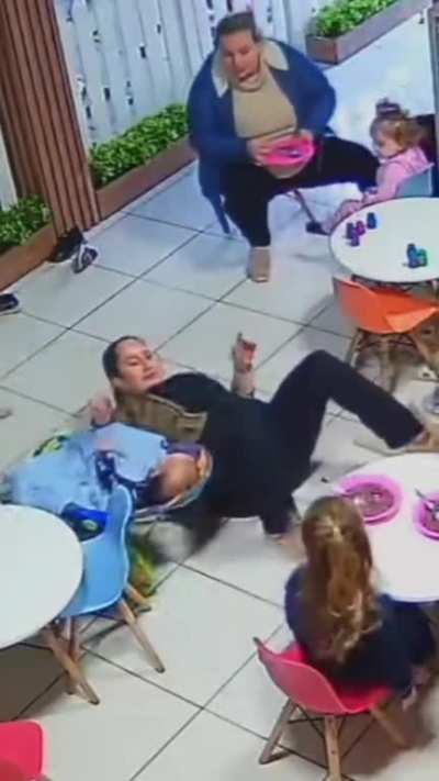 Baby moves chair and woman falls down while eating