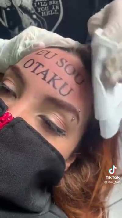 Teen couple tattooing 