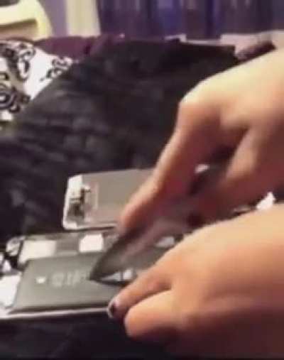 girl cuts open phone battery