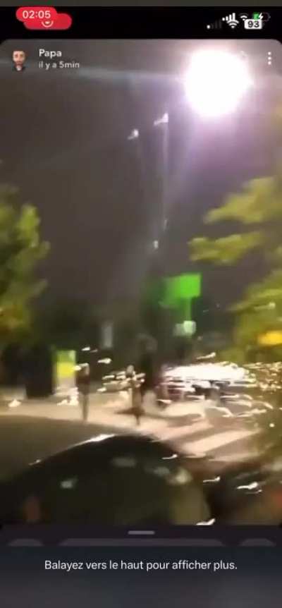 A protester in France cuts down a cctv pole and hits another protester 