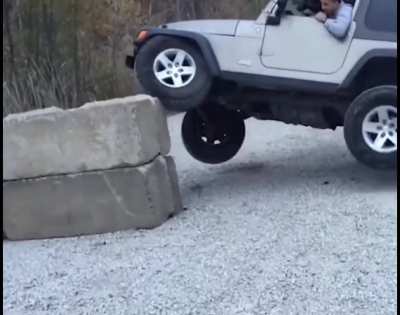Driving Jeep on Concrete barricade