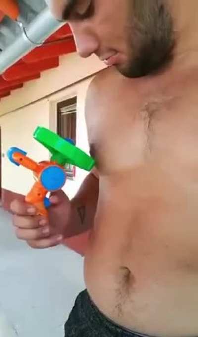 My brother hitting his own nipple on purpose with the propeller of a bubble blower toy