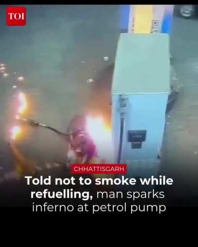 Guy lights gasoline on fire after being told not to smoke near it at a gas station.