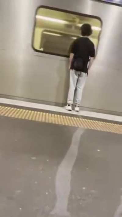 Trying to be funny by standing really close to a passing train.