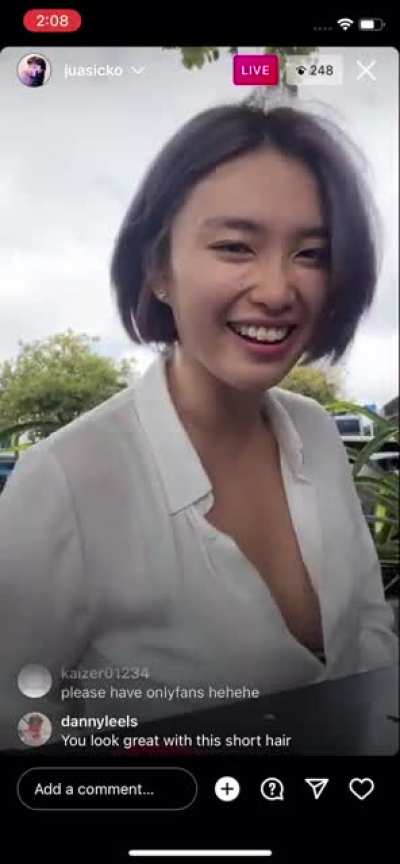 Sheer loose shirt being blown by the wind and revealing bosom. Instagram Live video on February 9, 2022