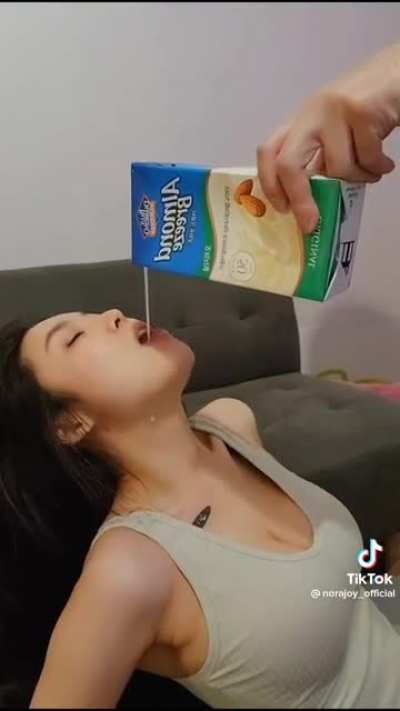 Busty woman drinking nut milk