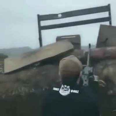 Ukraine soldiers, possibly Chechen fighters, fire a PKM at Russian militants while listening to hard bass