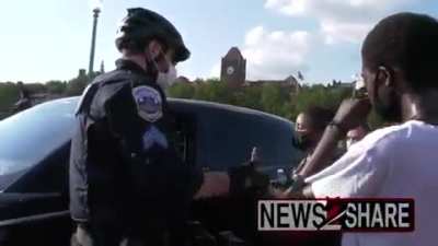 BLM protesters throws water after driver spit on them