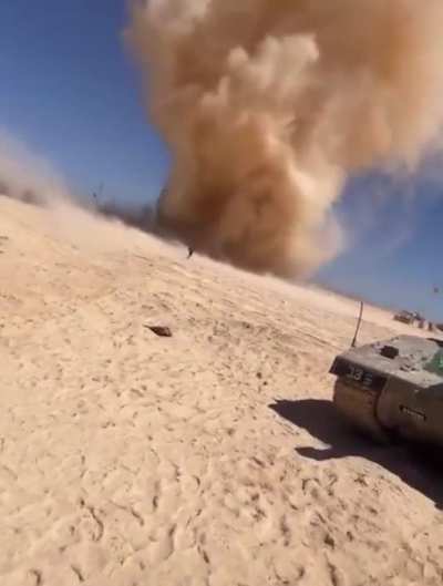 Soldier running into a dust devil