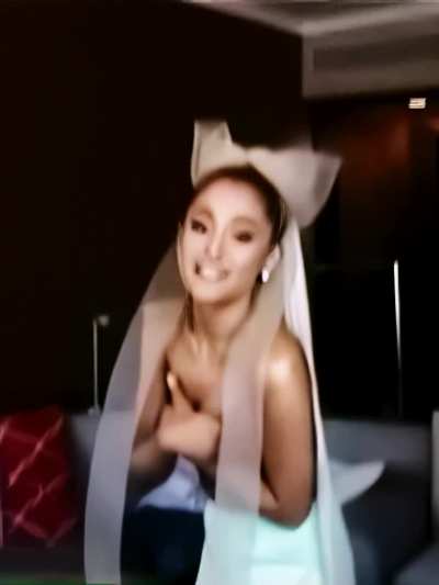 Ariana Grande holding her titties