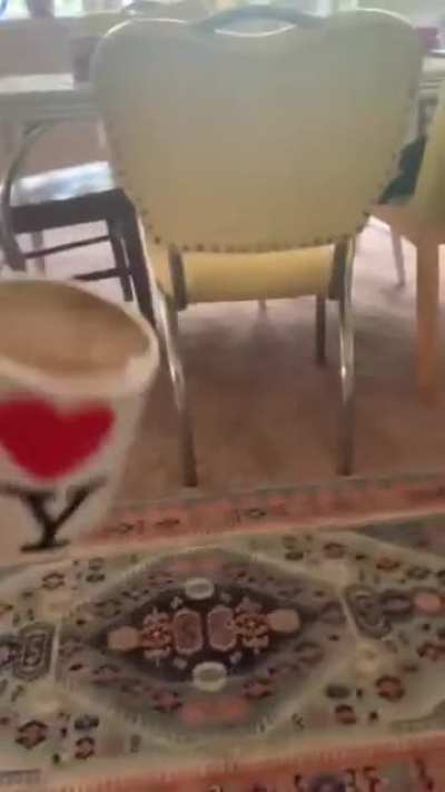 Playing with coffee cup top on the laptop.