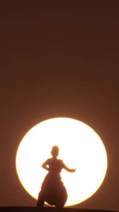 This young woman performs Bharatanatyam, an ancient Indian dance form, on a water tower as dawn breaks