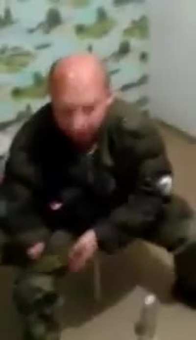 Russian soldier trying to break a vodka bottle over his head
