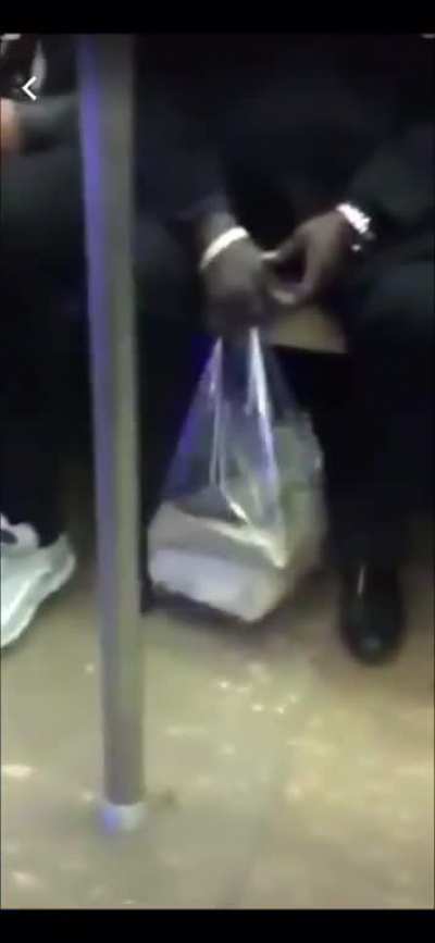 Guys share blunt on NYC subway