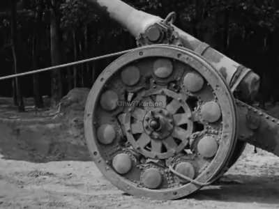 A team of Frenchmen moving six tons of Canon de 155 L modèle 1877/16 de Bange using a drag rope over the carriage wheel for leverage