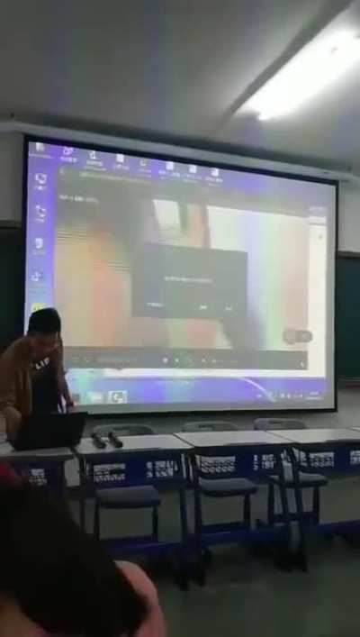 Guy plays the wrong video during a presentation for his class.