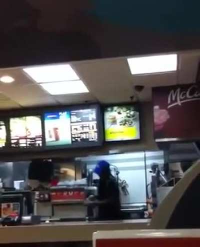 McDonald's cashier in Greenwich hits two customers with a stick after they slap him and jump the counter.