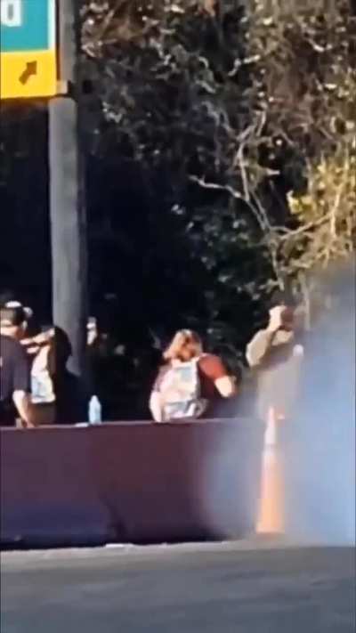 A car hits a traffic cone, and it flies into a guy's face