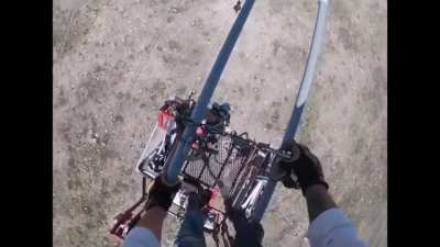 Lineman’s cart slips off the wires. He has to fix it so he get get off the lines.
