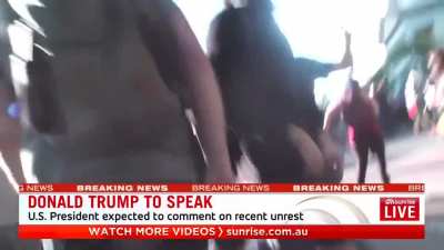 Cameraman POV, getting punched straight in the face by cops.
