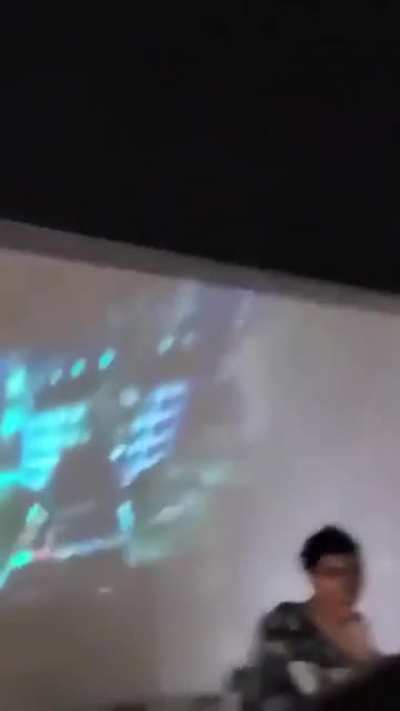 playing guitar hero projected on a moving semi