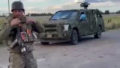Two Ukrainian soldiers have a talk to Russian old man nearby Russian destroyed equipment. Ukrainian incursion in Kursk region, 2024