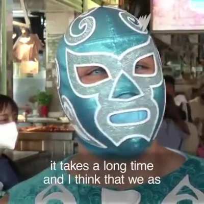 Professional wrestlers enforce the face mask rule at the Central de Abastos market in Mexico City.