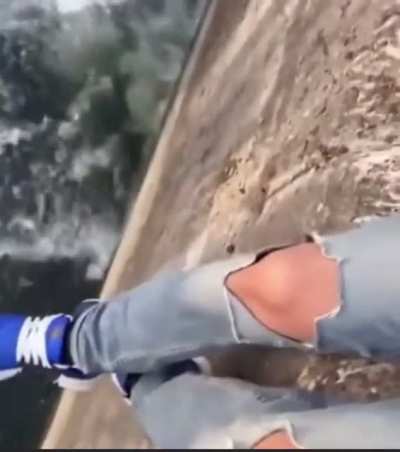 Swinging your girlfriend on a ledge