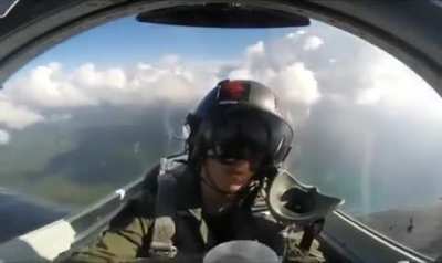 Fighter jet pilot drinking water while flying upside down.