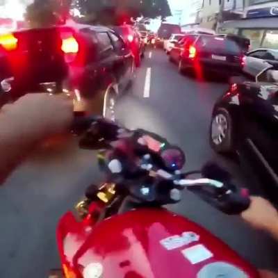 Motorcycle cuts through traffic