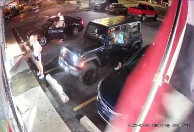 Idiots drive through a convenience storefront, in a parking lot, rages at witness